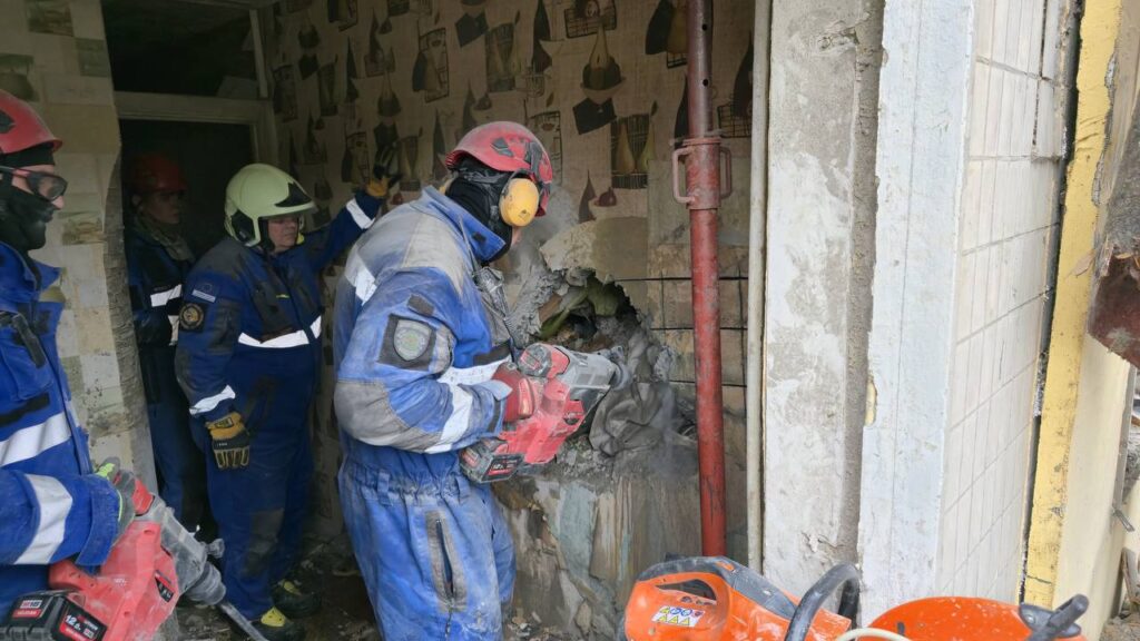 In Kyiv, rescuers pulled a man from under the rubble of a destroyed entrance